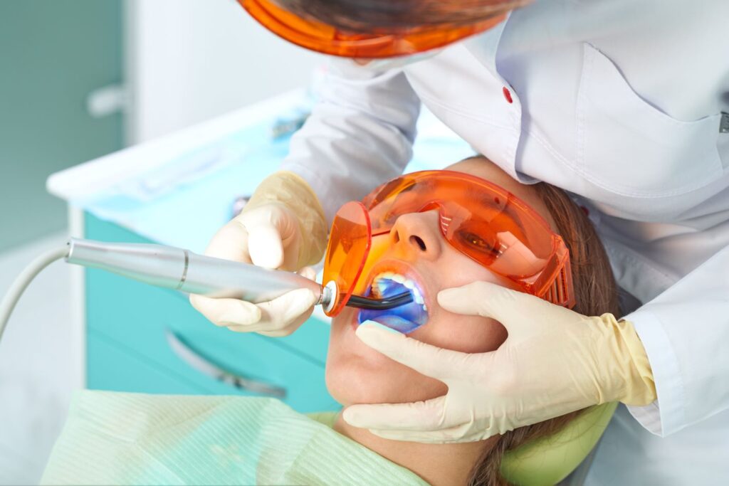 A woman getting a dental bonding procedure from her dentist.